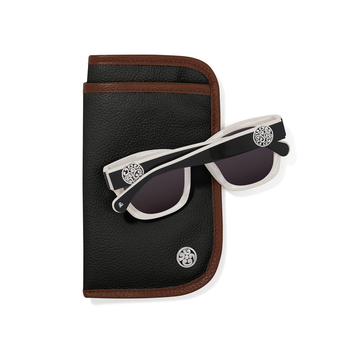 Brighton white and black sunglasses with silver-plated scroll medallions styled with a black leather case on a white background