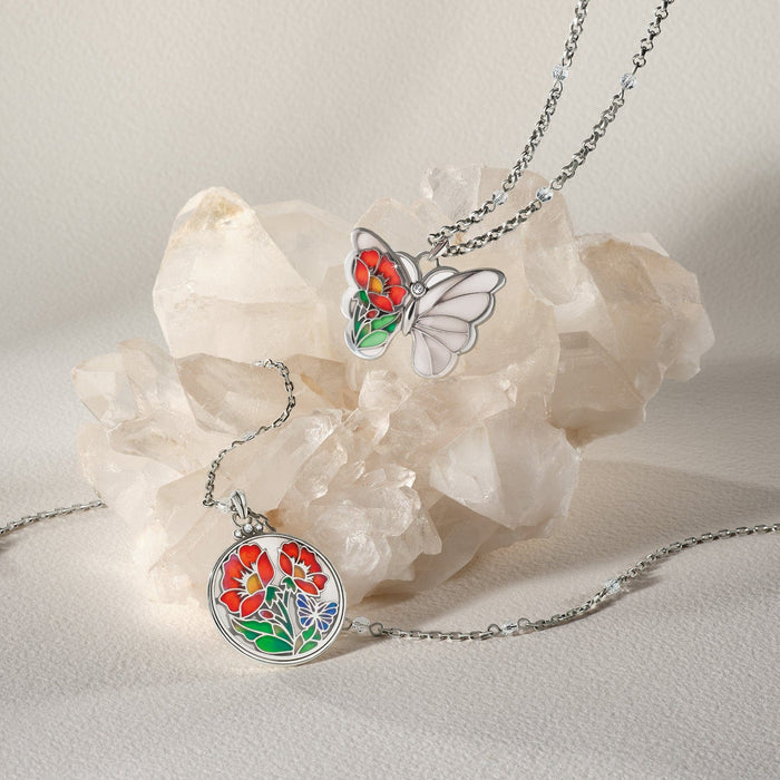 Brighton silver-plated necklaces styled with butterfly and floral enamel pendants on a quartz crystal cluster