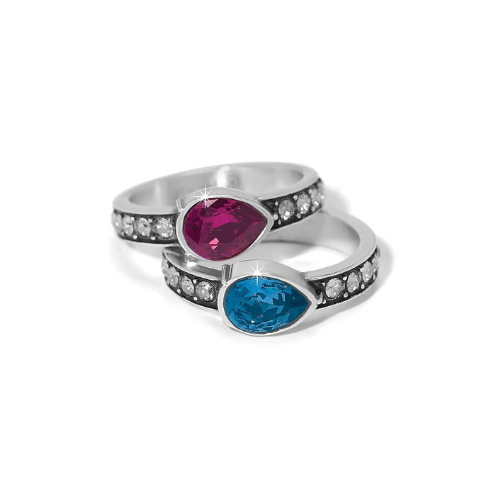 Brighton stackable rings with pink and blue teardrop crystals and silver-plated bands with crystal accents on a white background