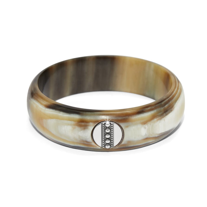 Brighton bangle bracelet in buffalo horn with brown and cream striations and silver-plated medallion on a white background