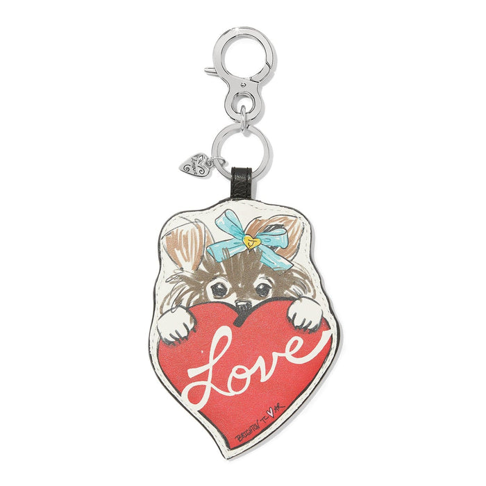 Brighton leather bag charm with illustrated puppy holding a red Love heart and silver-tone clasp on a white background