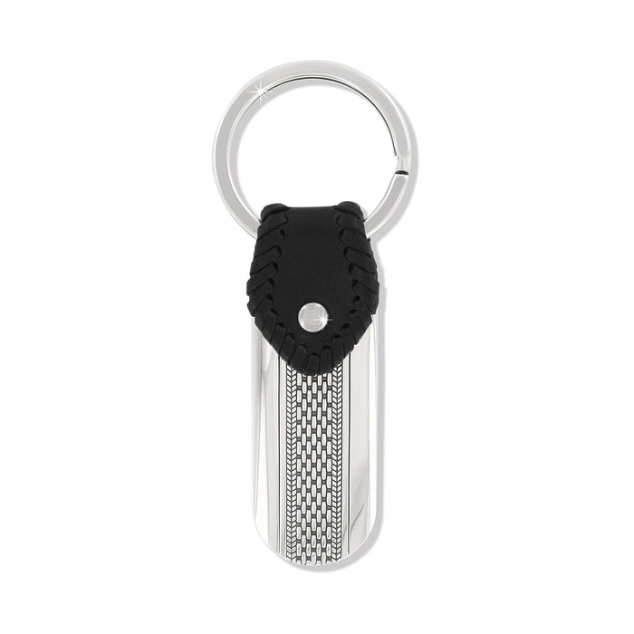 Brighton key fob with silver-tone engraved tag, woven chain detail, and black leather accent on a white background