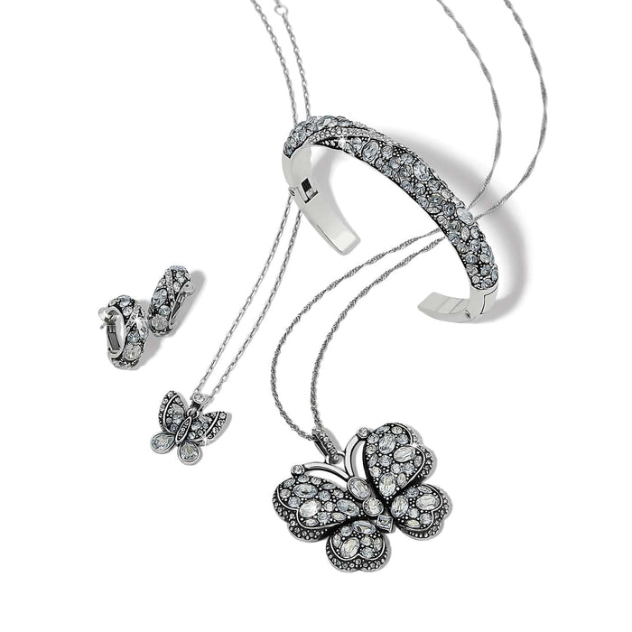 Brighton silver-plated butterfly jewelry set styled with crystal cuff bracelet and matching hoop earrings on white background