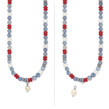 Brighton beaded necklace with blue, red, and white beads, silver-plated accents, and detachable pearl charm on a white background