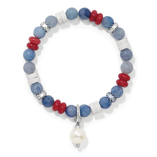 Brighton beaded bracelet with blue, red, and white stones, silver-plated accents, and pearl drop charm on a white background