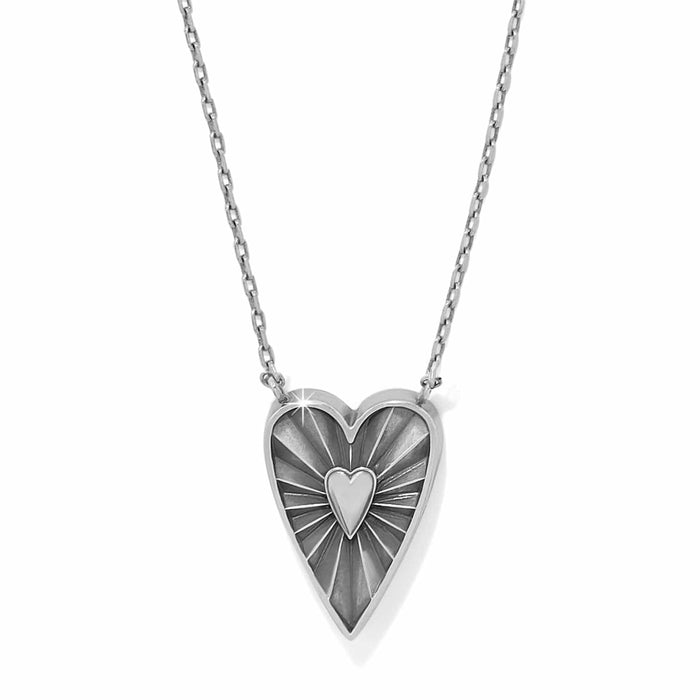 Brighton pendant necklace with two-tone heart medallion featuring radiating sunburst design and small center heart on a white background