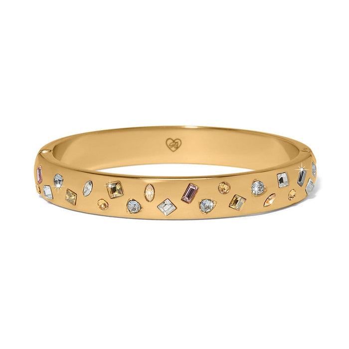 Brighton gold-plated bangle bracelet with scattered multicolored crystals in various shapes and sizes on a white background
