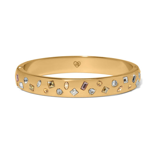 Brighton gold-plated bangle bracelet with scattered multicolored crystals in various shapes and sizes on a white background