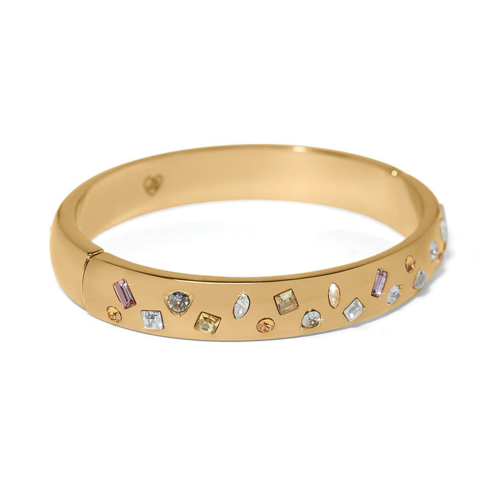Brighton gold-plated bangle bracelet with scattered multicolored crystals in assorted shapes and sizes on a white background