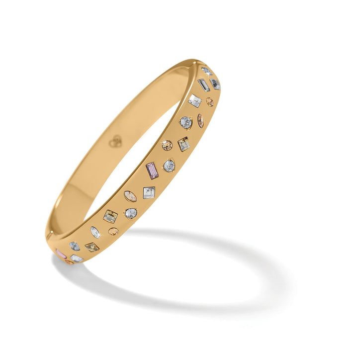 Brighton gold-plated bangle bracelet with scattered multicolored crystals in various shapes and sizes on a white background