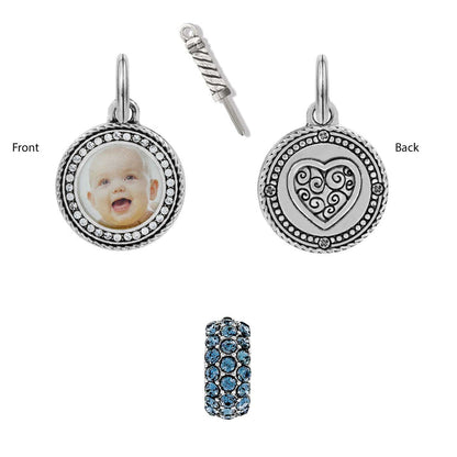 Brighton silver-plated photo charm with crystal border, heart-engraved back, screwdriver, and blue crystal bead on white background