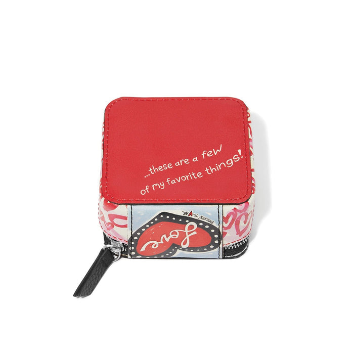 Brighton zip pouch shown from the top with red panel, heart graphic print, and black zipper pull on a white background