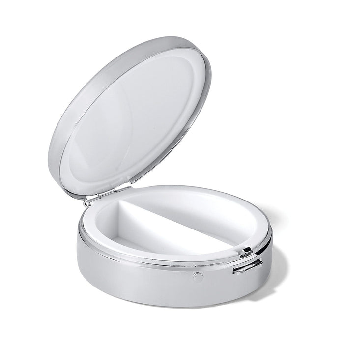 Brighton round pill box shown open with silver-tone exterior and white divided interior compartments on a white background