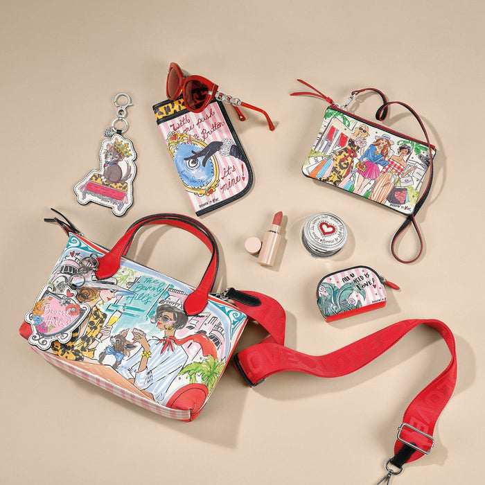 Brighton handbag with illustrated Beverly Hills print, styled with sunglasses and other accessories on a neutral background