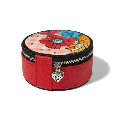 Brighton round leather jewelry case in red with floral print top, silver zipper, and heart charm on a white background