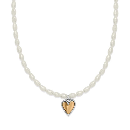 Brighton pearl necklace with rice pearls and two-tone heart pendant in silver and gold on a white background