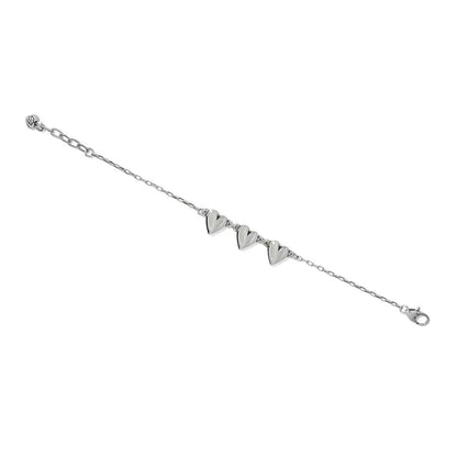 Brighton bracelet with three silver-tone heart charms, delicate chain, and lobster clasp on a white background