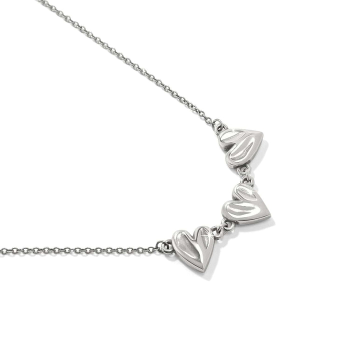 Brighton necklace with three linked silver-tone heart charms on a delicate cable chain on a white background