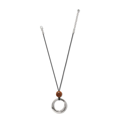 Brighton pendant necklace with silver-plated ring, wood bead, and black nylon cord on a white background