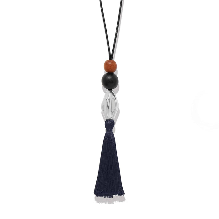 Brighton tassel pendant necklace with wood beads, silver-plated accent, and navy tassel on black cord on a white background