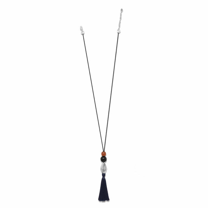 Brighton pendant necklace with wood beads, silver-plated accent, and navy nylon tassel on cord on a white background