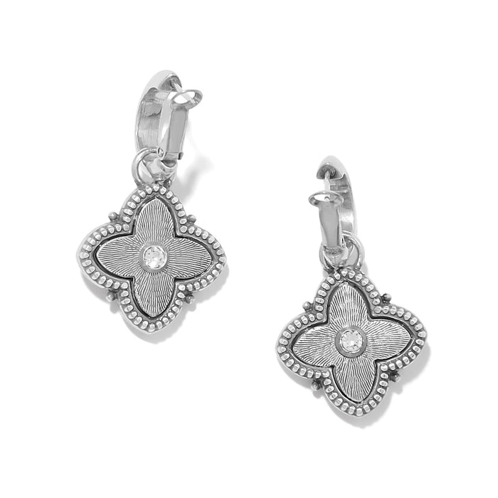 Brighton hoop earrings with silver-tone four-petal flower charms and crystal centers on a white background