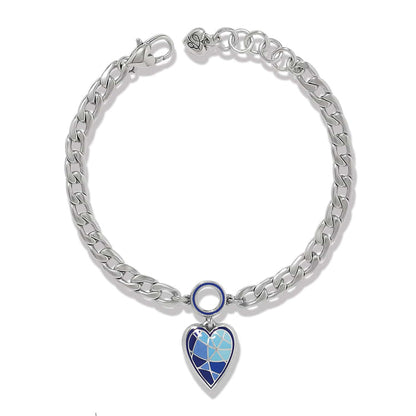 Brighton charm bracelet with silver-plated curb chain and blue enamel heart pendant on a white background