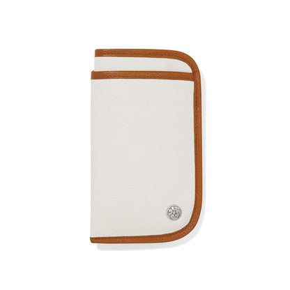 Brighton white leather wallet with tan trim and silver-plated medallion accent on a white background