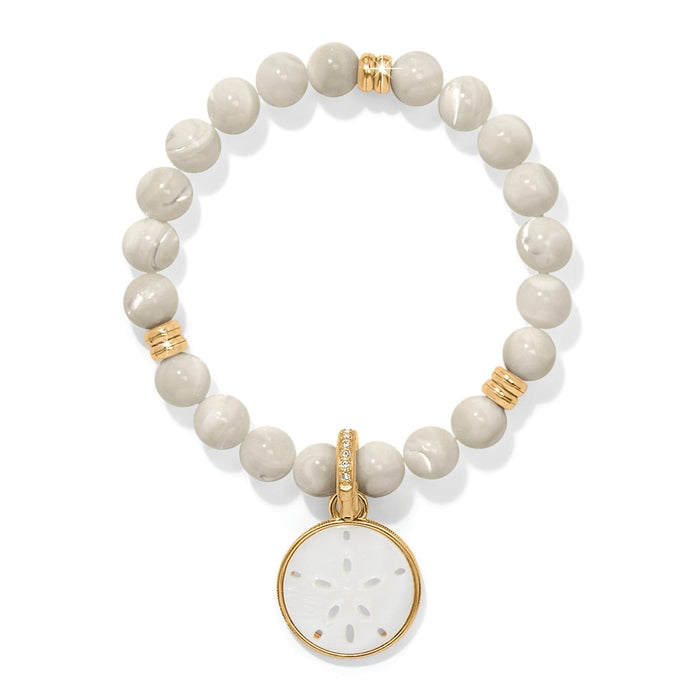 Brighton beaded bracelet with cream stone beads, gold-plated accents, and mother-of-pearl sand dollar charm on a white background