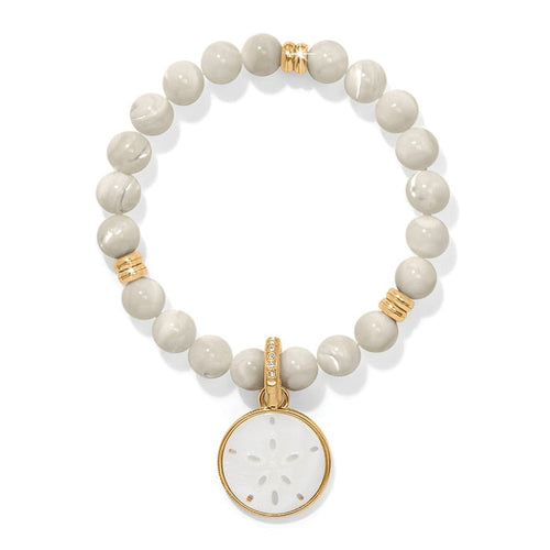 Brighton beaded bracelet with cream stone beads, gold-plated accents, and mother-of-pearl sand dollar charm on a white background