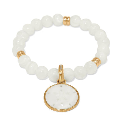 Brighton beaded bracelet with mother-of-pearl beads, gold-plated accents, and sand dollar charm on a white background