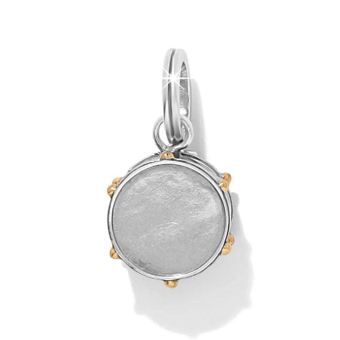Brighton round charm with white enamel center, silver-tone frame, and gold-tone bead accents on a white background