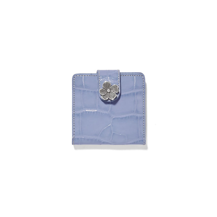Brighton bifold wallet in lavender croc-embossed leather with silver-tone flower closure on a white background