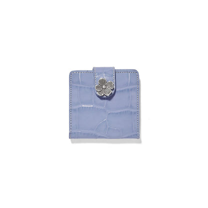 Brighton bifold wallet in lavender croc-embossed leather with silver-tone flower closure on a white background