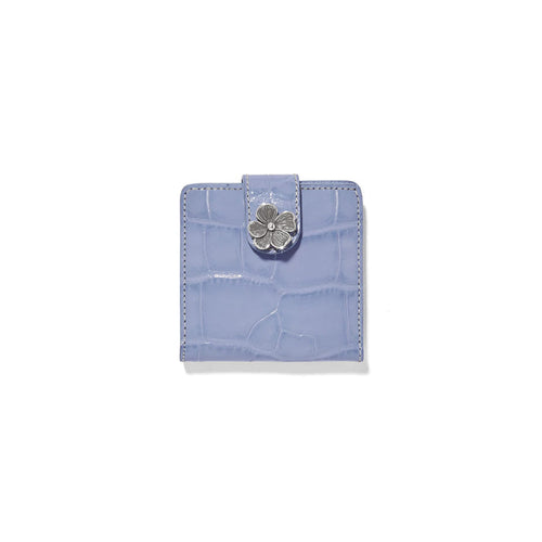 Brighton bifold wallet in lavender croc-embossed leather with silver-tone flower closure on a white background