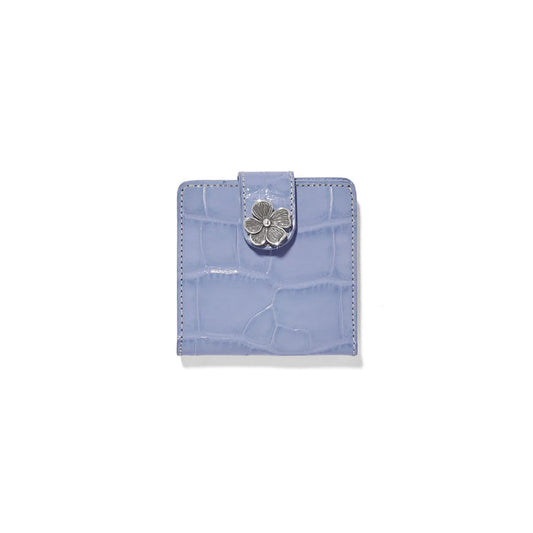 Brighton bifold wallet in lavender croc-embossed leather with silver-tone flower closure on a white background