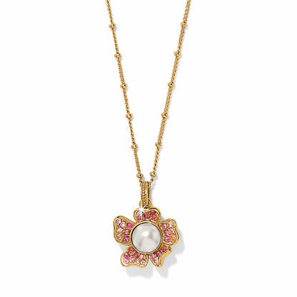 Brighton pendant necklace with gold-plated flower, glass pearl center, and pink crystal petals on a white background