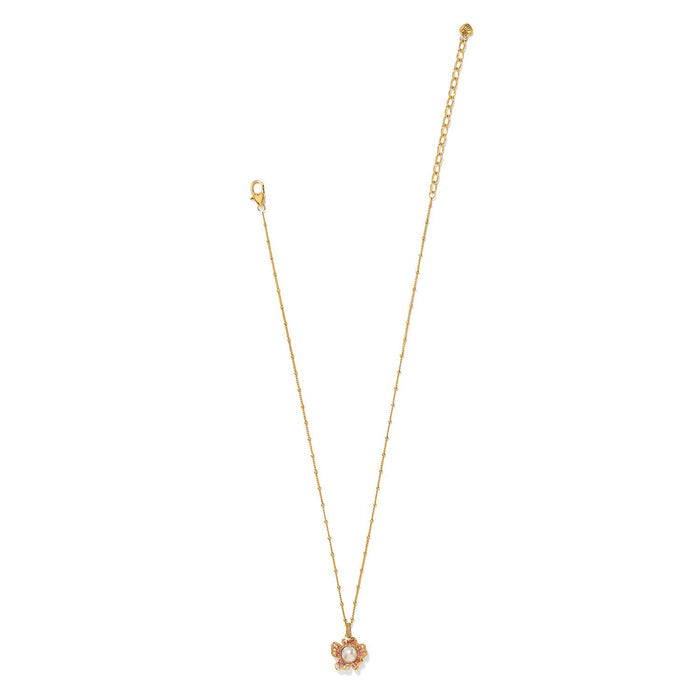 Brighton gold-plated pendant necklace with glass pearl and pink crystal flower accent on a white background