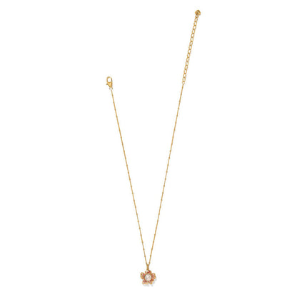 Brighton gold-plated pendant necklace with glass pearl and pink crystal flower accent on a white background