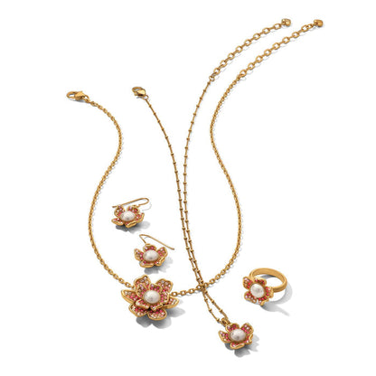 Brighton gold-plated jewelry set with floral pearl and pink crystal necklace, earrings, and ring on a white background