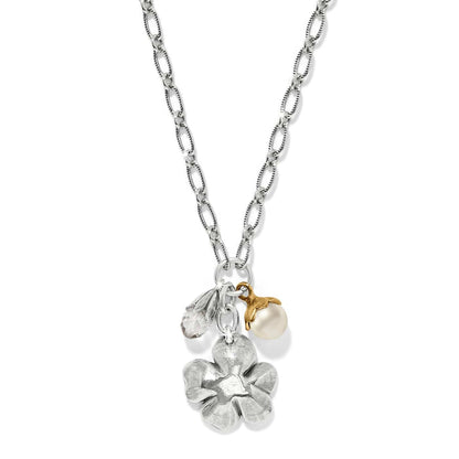 Brighton charm necklace with silver-tone flower, glass pearl, and crystal bead on two-tone chain on a white background