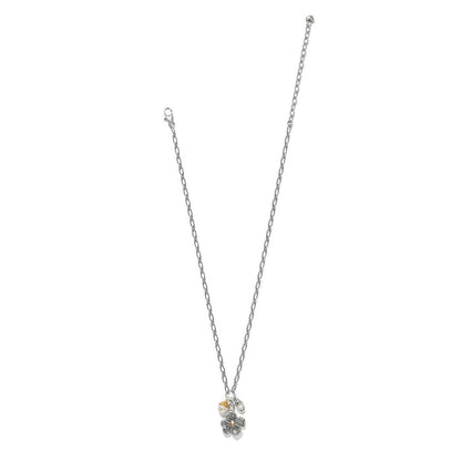 Brighton charm necklace with two-tone flower pendant, glass pearl, and bead accents on a white background