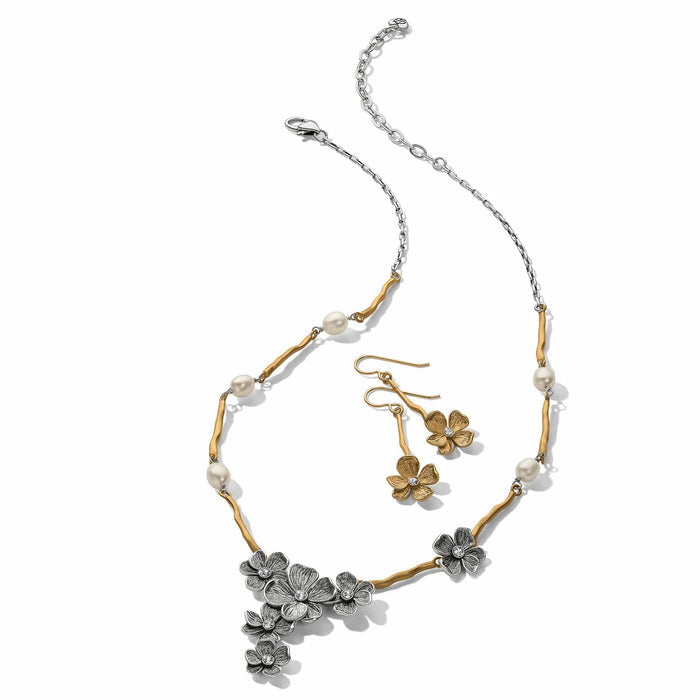 Brighton necklace and earrings set with silver-plated flowers, gold-plated branches, pearls, and crystal accents on a white background