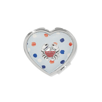 Brighton heart-shaped compact mirror with light blue polka dot design and red crystal crab accent on a white background