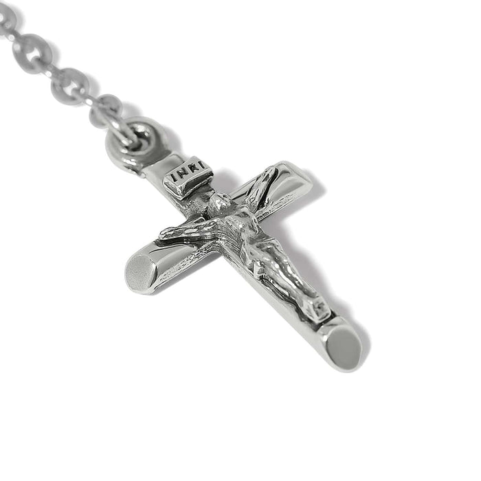 Close-up of Brighton silver-plated crucifix pendant with detailed figure of Christ and INRI inscription on chain