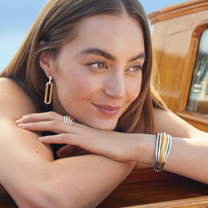 Model wearing Brighton two-tone drop earrings with coordinating Brighton ring and bangle bracelets in silver and gold