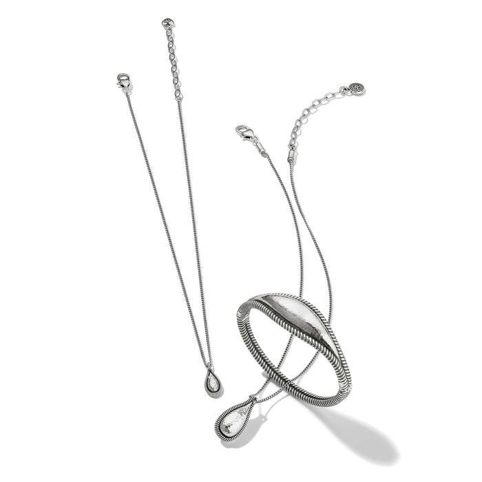 Brighton silver-plated necklace and bangle bracelet set with hammered teardrop pendant and textured oval bangle on a white background