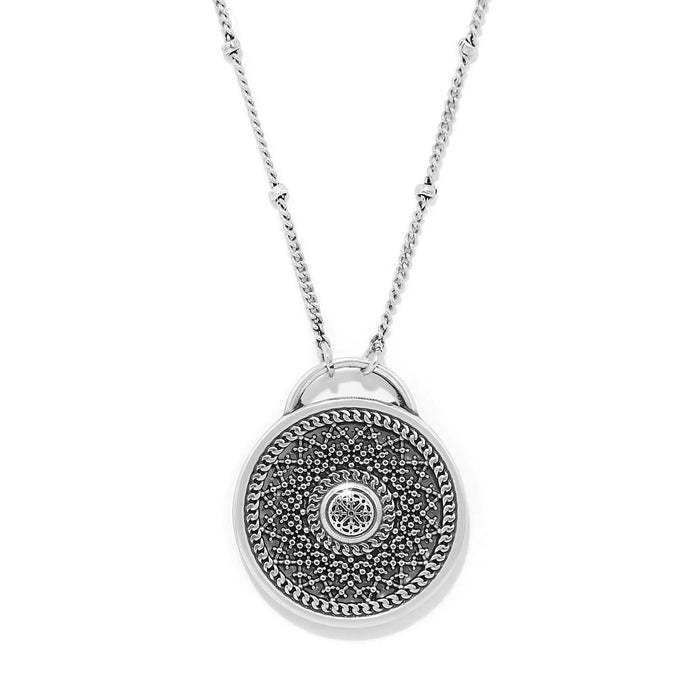 Brighton pendant necklace with round medallion featuring intricate dotted filigree pattern and beaded chain on a white background