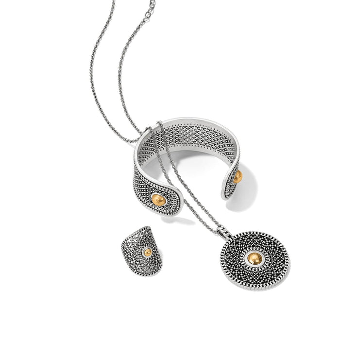 Brighton jewelry set styled with two-tone cuff bracelet, ring, and pendant necklace featuring textured silver and gold accents