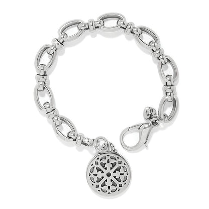 Brighton charm bracelet with silver-plated oval link chain, lobster clasp, and round filigree medallion on a white background